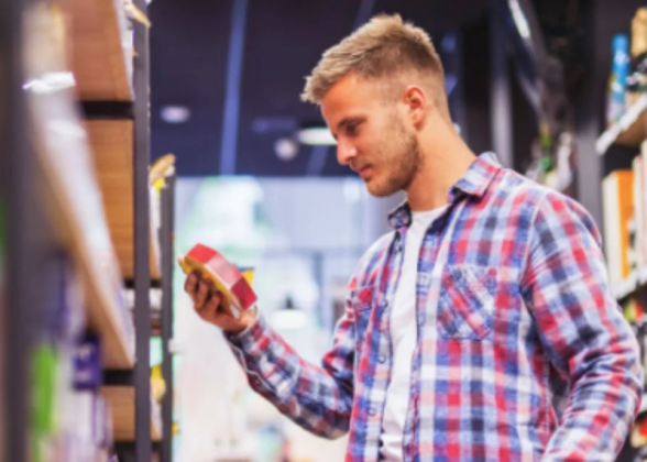A customer looking at a product from a shelf