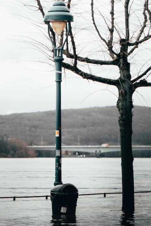 A street lamp in a flooded street. 