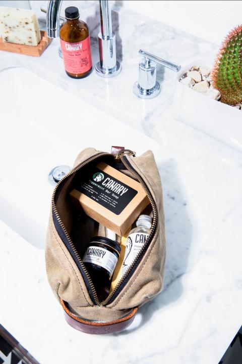 Canary concentrated products in toiletry bag in bathroom