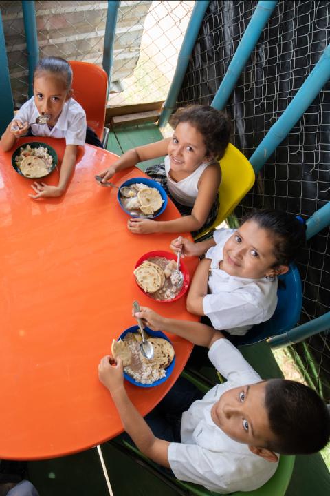 Feed the Children - children eating at the table - fighting hunger