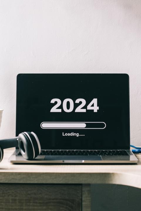 New Year 2024 - 2024 shows as loading on a computer in a home office