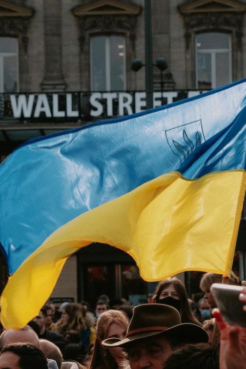 demonstrators hold ukrainian flag in support of ukraine amidst russian war