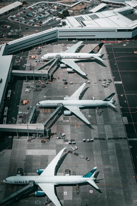 Planes parked on the tarmac at an airport. 