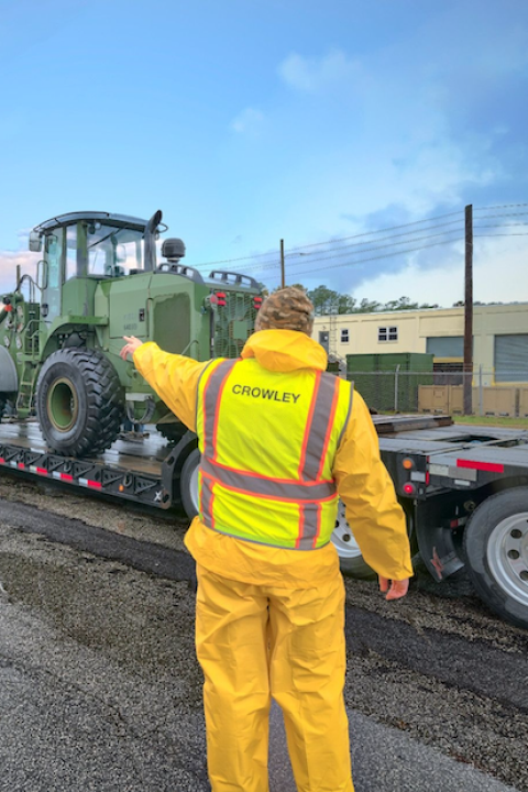 man with crowley vest on standing by line of trucks copy