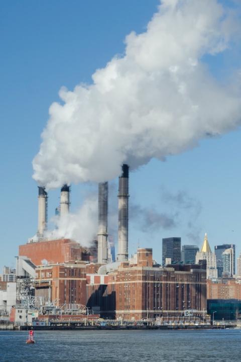 pollution from power plant against new york city skyline - air pollution - climate change - SEC climate disclosure rule