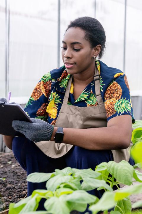 young woman using data for farming - justice for black farmers