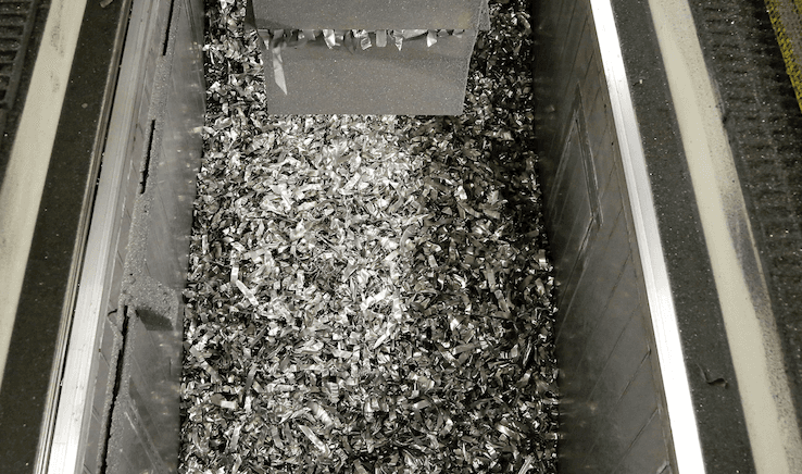 Aluminum-chips-go-down-a-conveyer-belt-at-a-Ford-stamping-plant.png