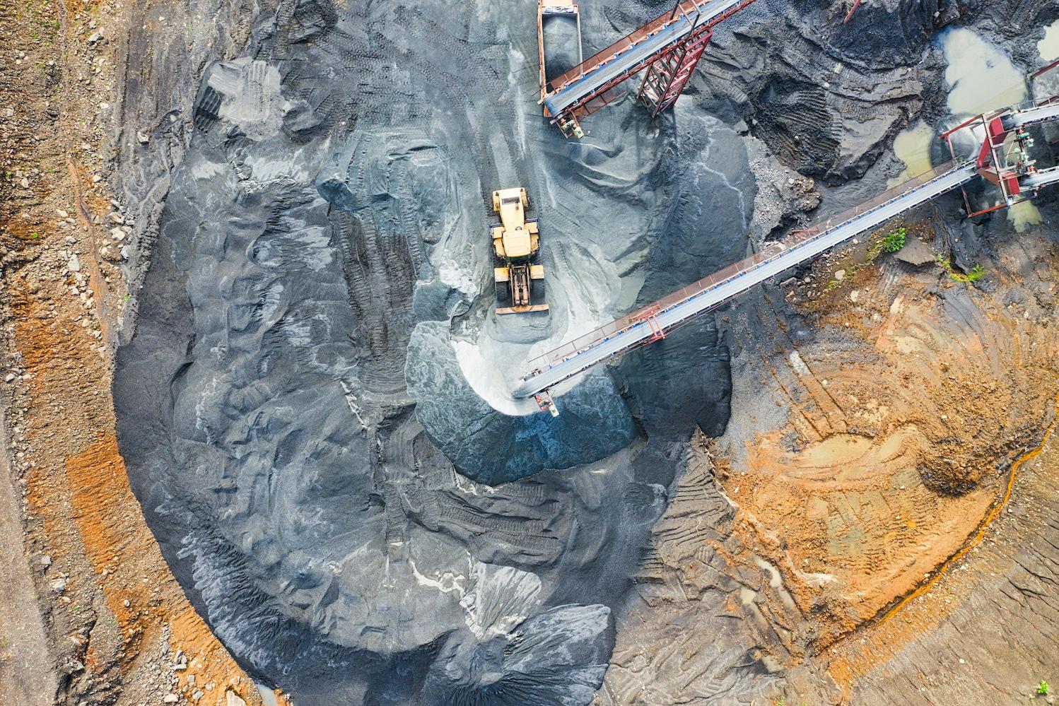 Aerial view of heavy machinery at a mine. 