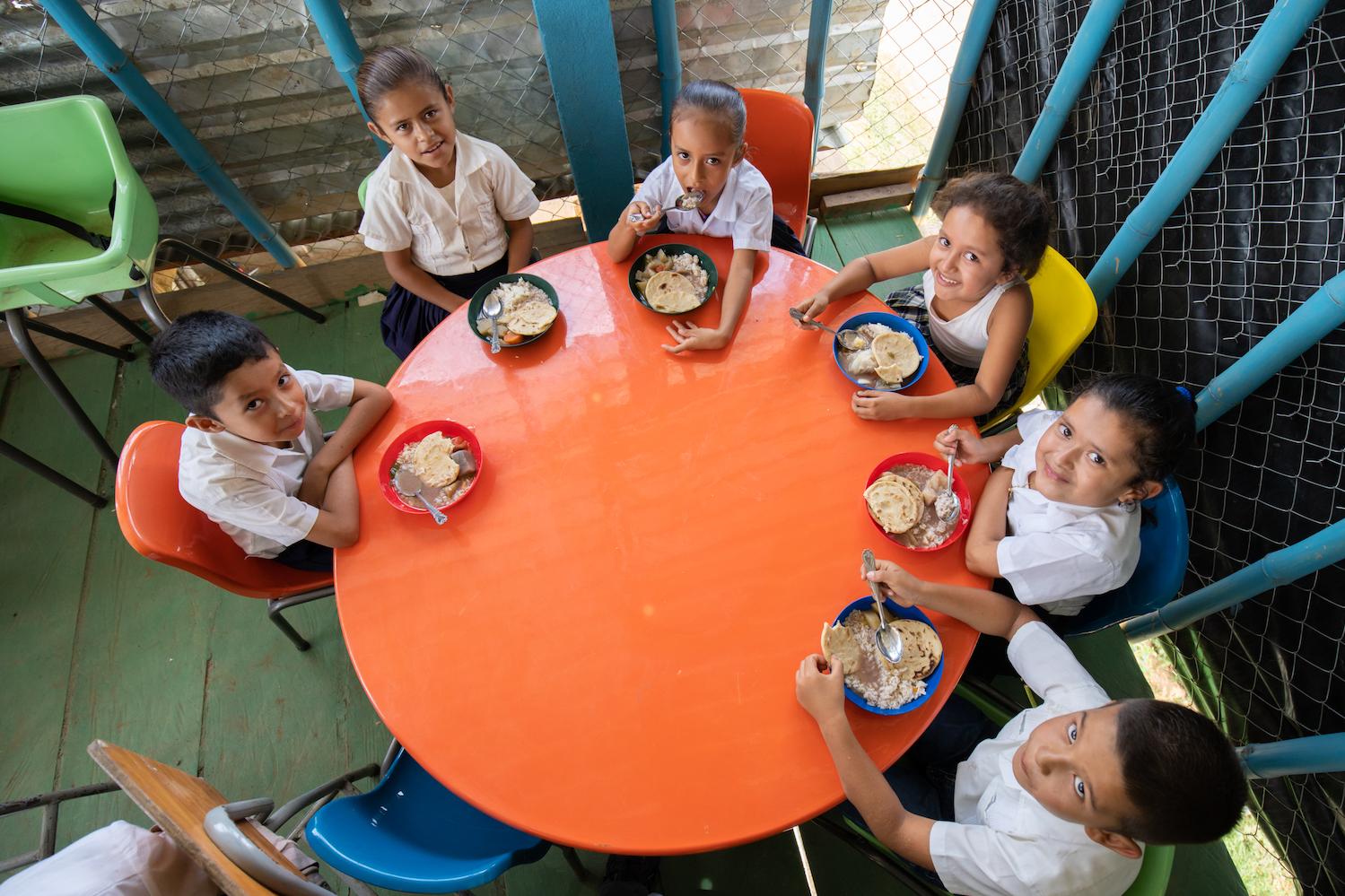Feed the Children - children eating at the table - fighting hunger