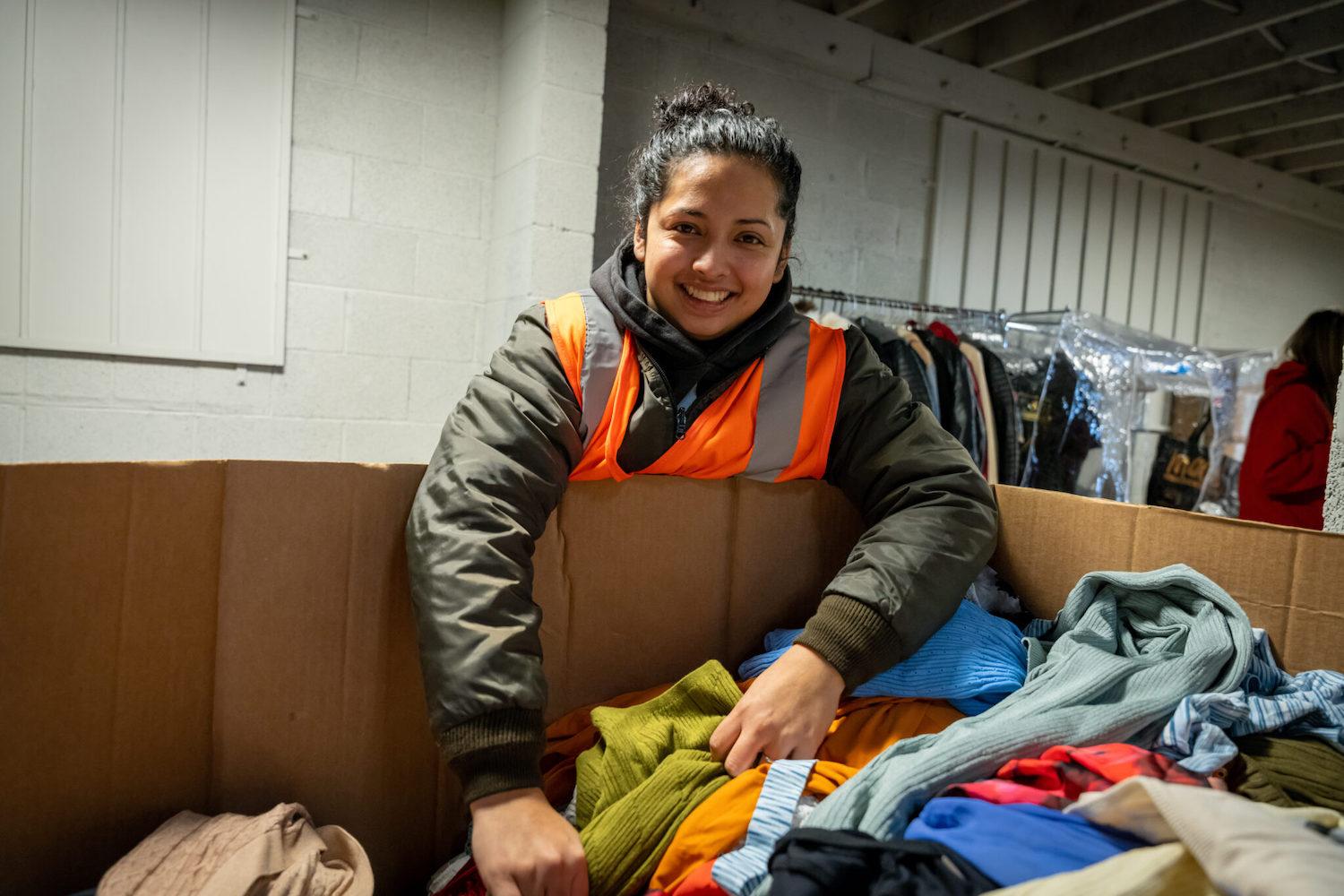 employee sorts clothes at Homeboy Threads - Homeboy Industries second chance hiring