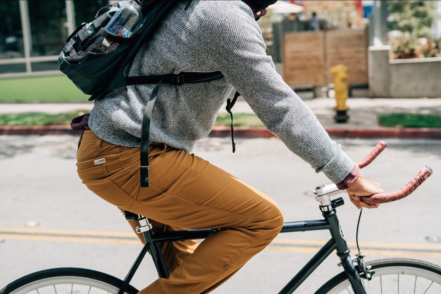Man riding a bicycle in Livsn pants made from recycled buoys