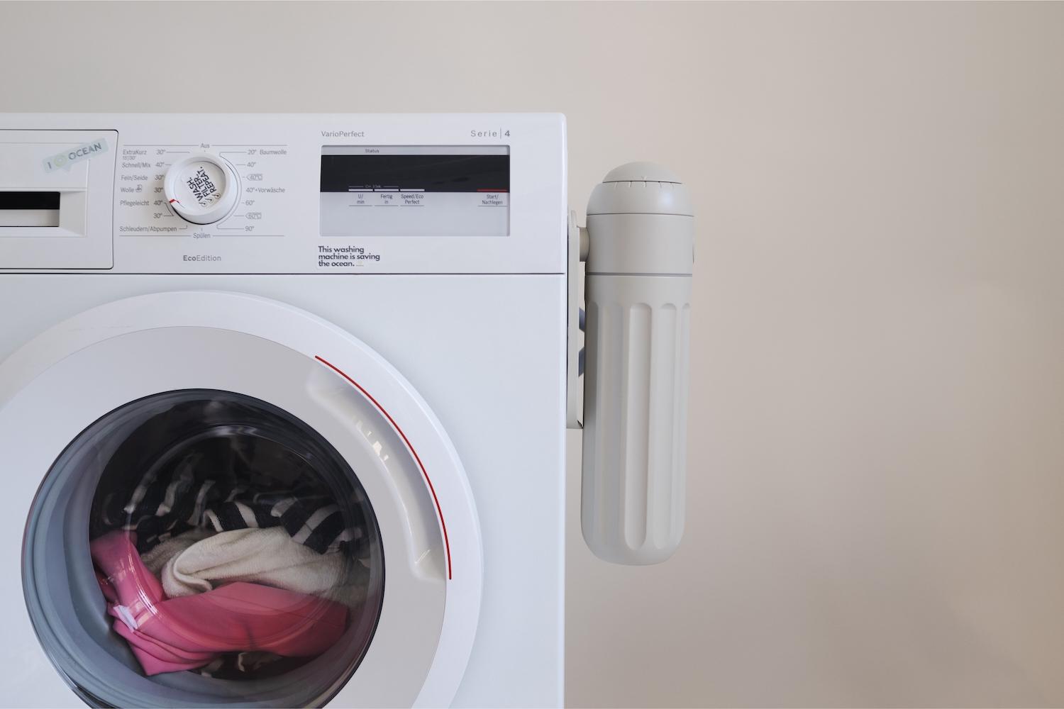 PlanetCare&#039;s microfiber filter attached to the side of a laundry machine. 