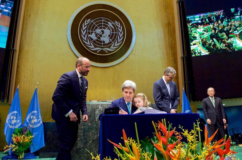 Secretary_Kerry_Holds_Granddaughter_Dobbs-Higginson_on_Lap_While_Signing_COP21_Climate_Change_Agreement_at_UN_General_Assembly_Hall_in_New_York_26512345421.jpg