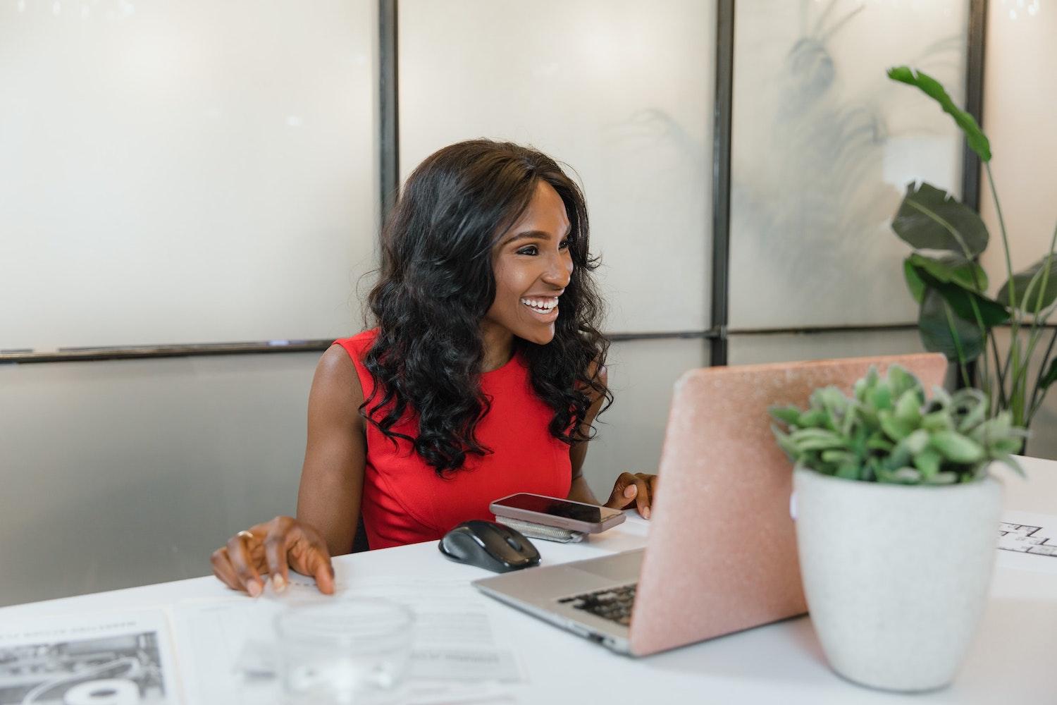 black woman entrepreneur takes meeting on laptop - minority-owned businesses