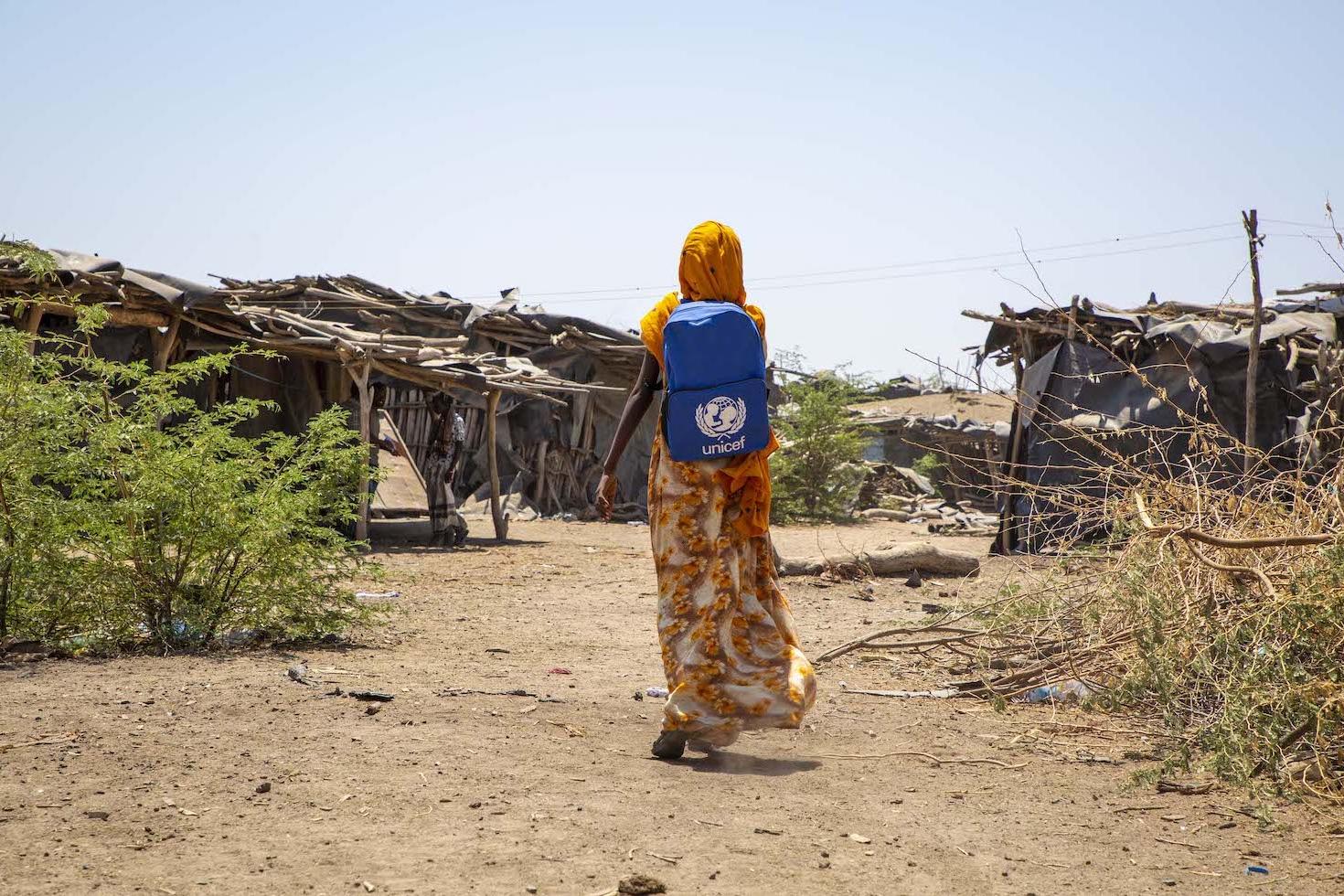 climate change refugee miriam who was displaced by floods in northern ethiopia walks to school with unicef backpack