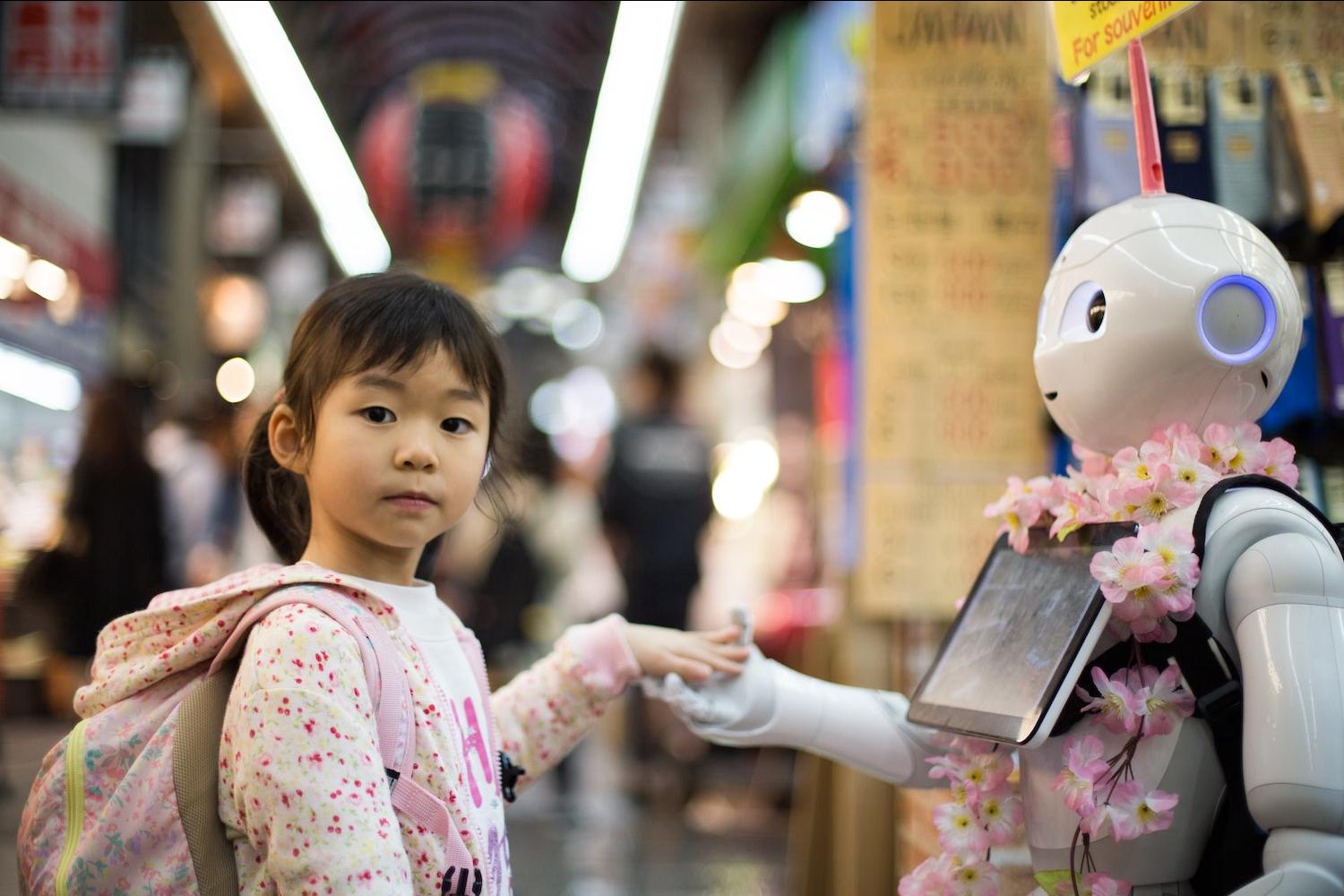 little girl makes friends in a robot - how automation can solve for population decline