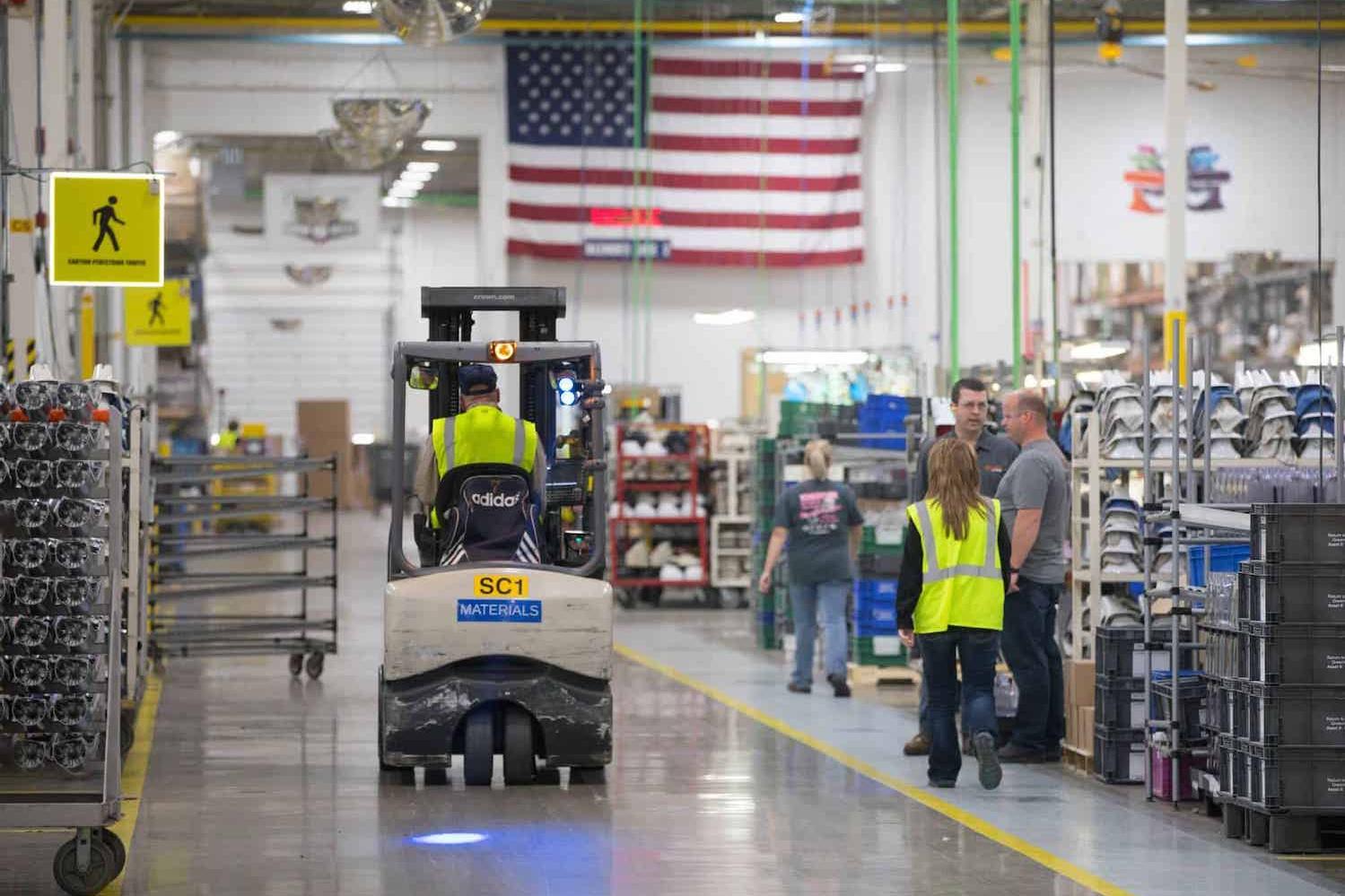 man drives forklift in warehouse - second chance hiring