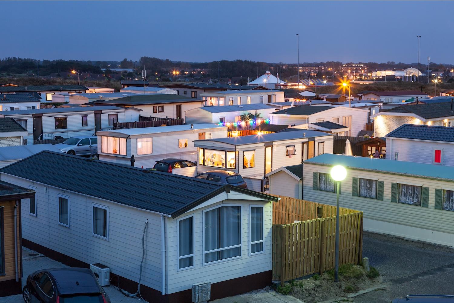 mobile homes in a mobile home park at sunset - mobile home owners are forming mobile home co-ops for climate resilience