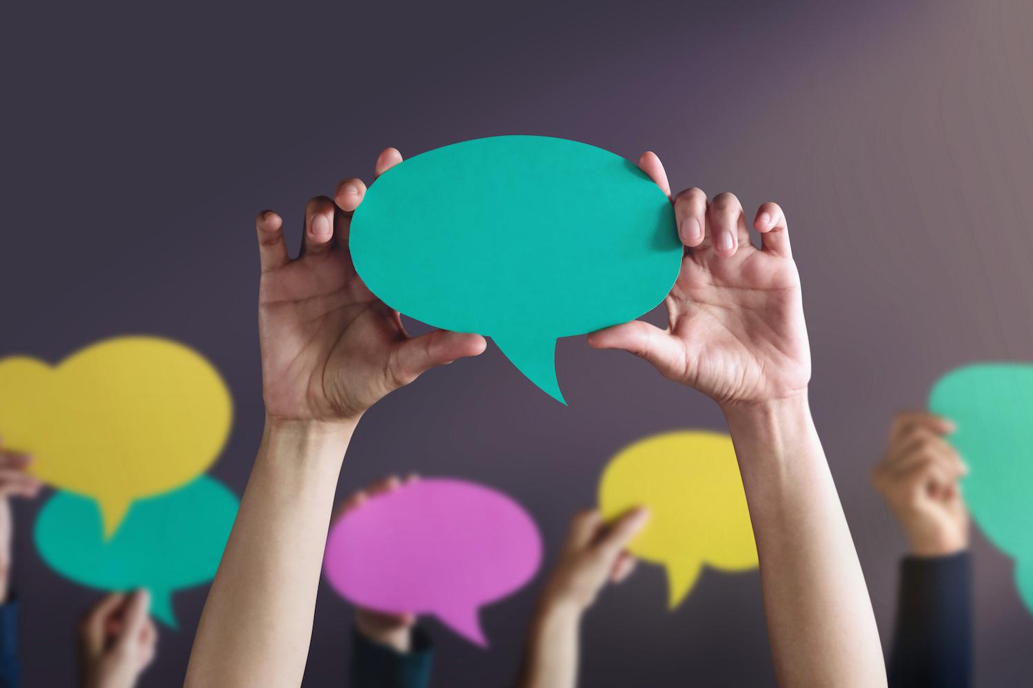 people holding up conversation bubbles - what Americans have to say about ESG