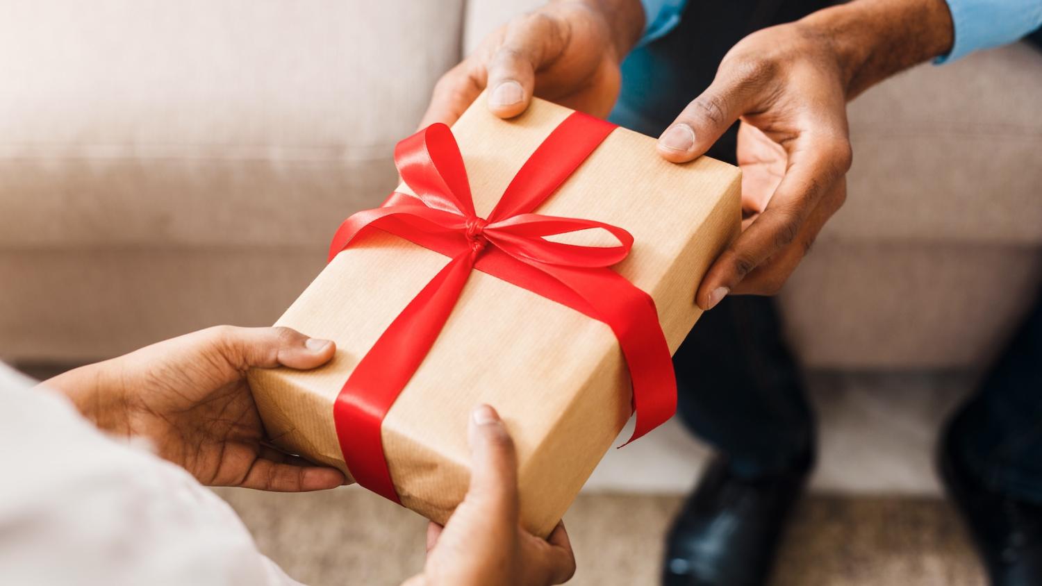 person giving a gift - GivingTuesday