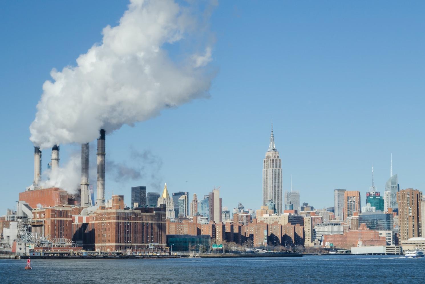 pollution from power plant against new york city skyline - air pollution - climate change - SEC climate disclosure rule