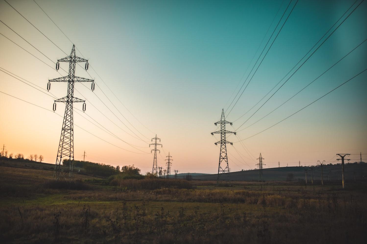 power lines at sunset - decarbonizing the energy grid to fight climate change