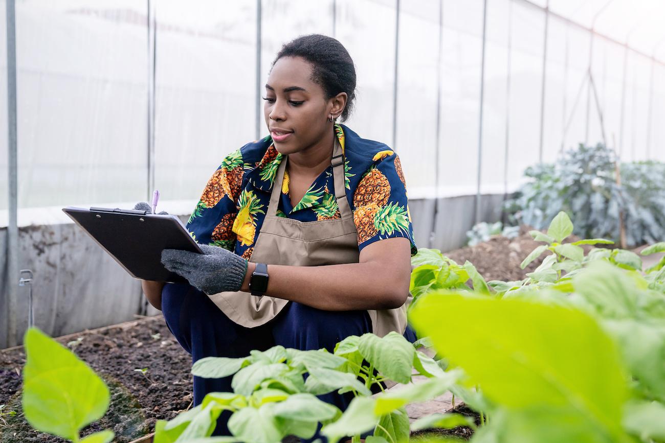 young woman using data for farming - justice for black farmers 