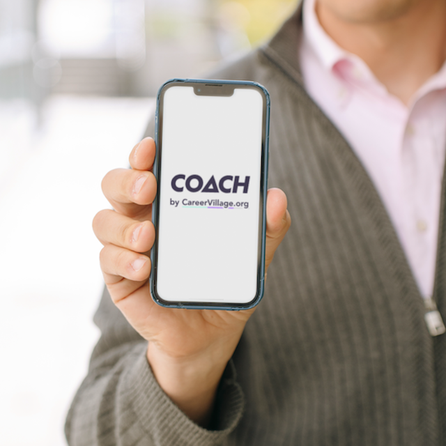 CareerVillage Founder Jared Chung holds a phone showing the welcome page of the organization's AI career coach.