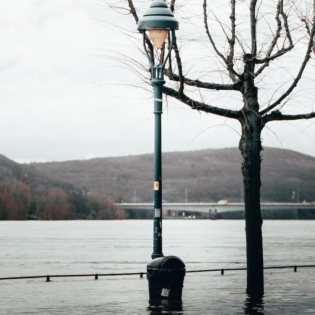 A street lamp in a flooded street. 