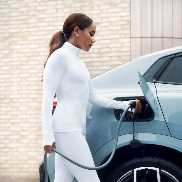 Alex Scott charging an electric vehicle in BMW EV campaign