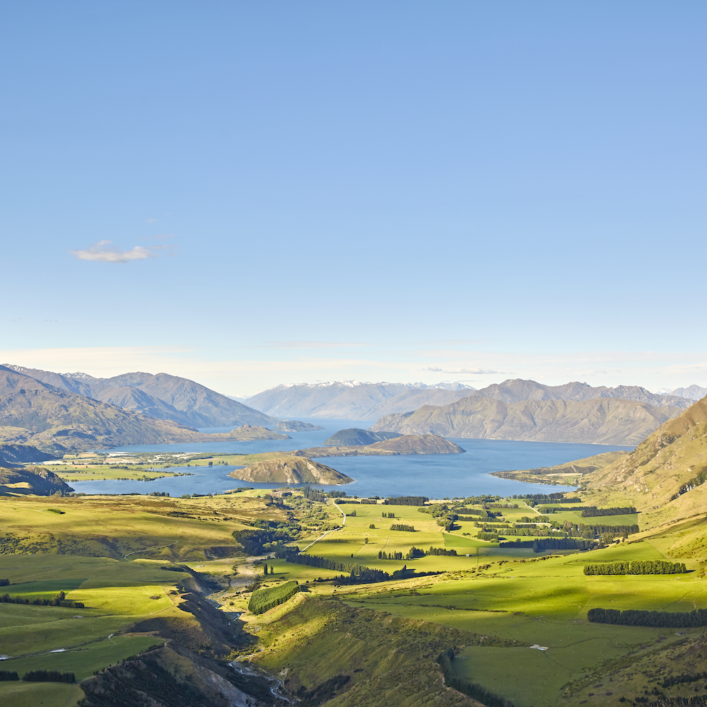New Zealand — green mountains and fields, lakes and blue sky — grazing land for farmers