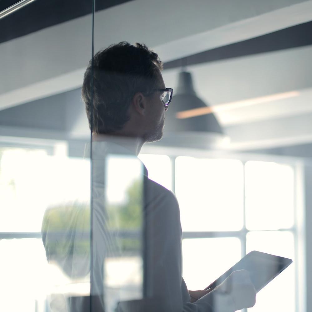 CEO executive in board room with glass windows - ESG reporting in business
