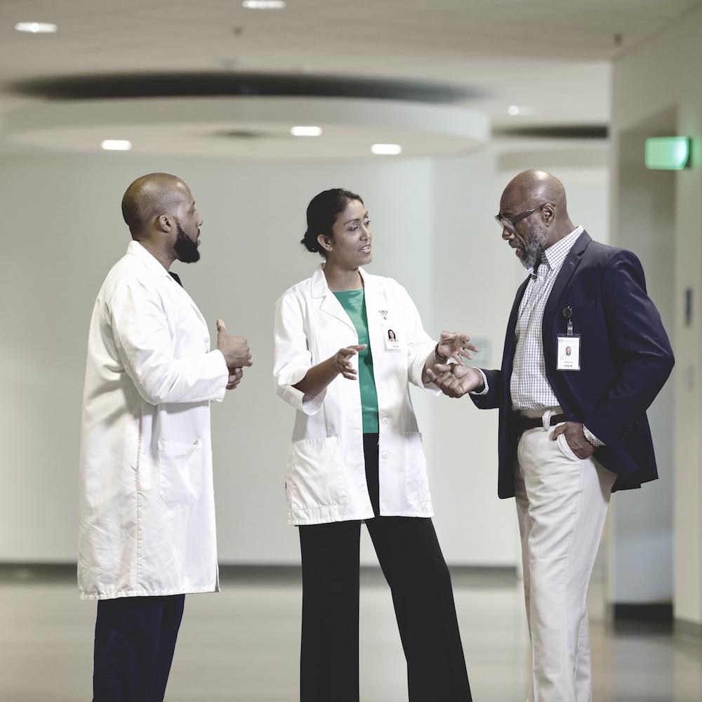 Doctors talking in a hospital - ensuring diversity in clinical trials