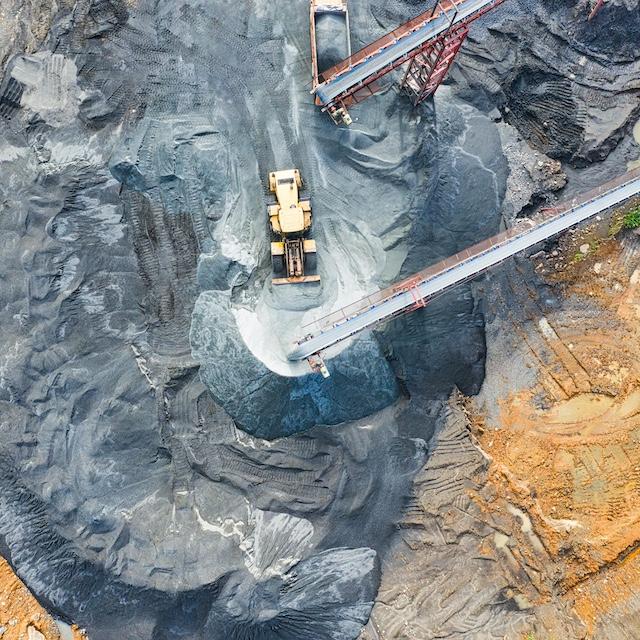 Aerial view of heavy machinery at a mine. 