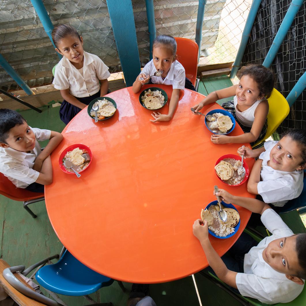 Feed the Children - children eating at the table - fighting hunger