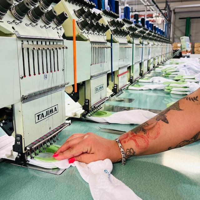 An employee sews socks at a FutureStitch manufacturing facility. 
