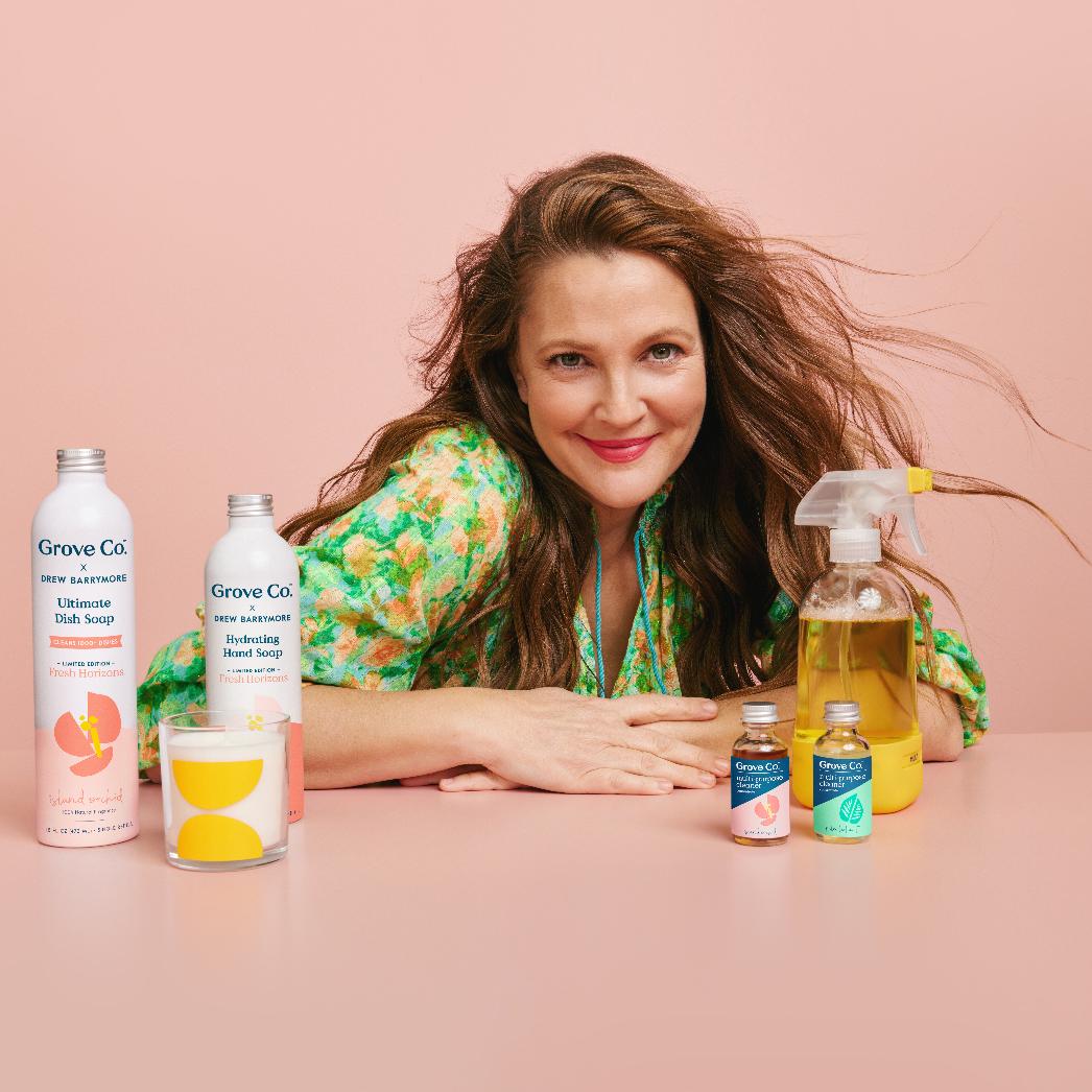 A photo of celebrity Drew Barrymore posing with her new Grove Co. product line.