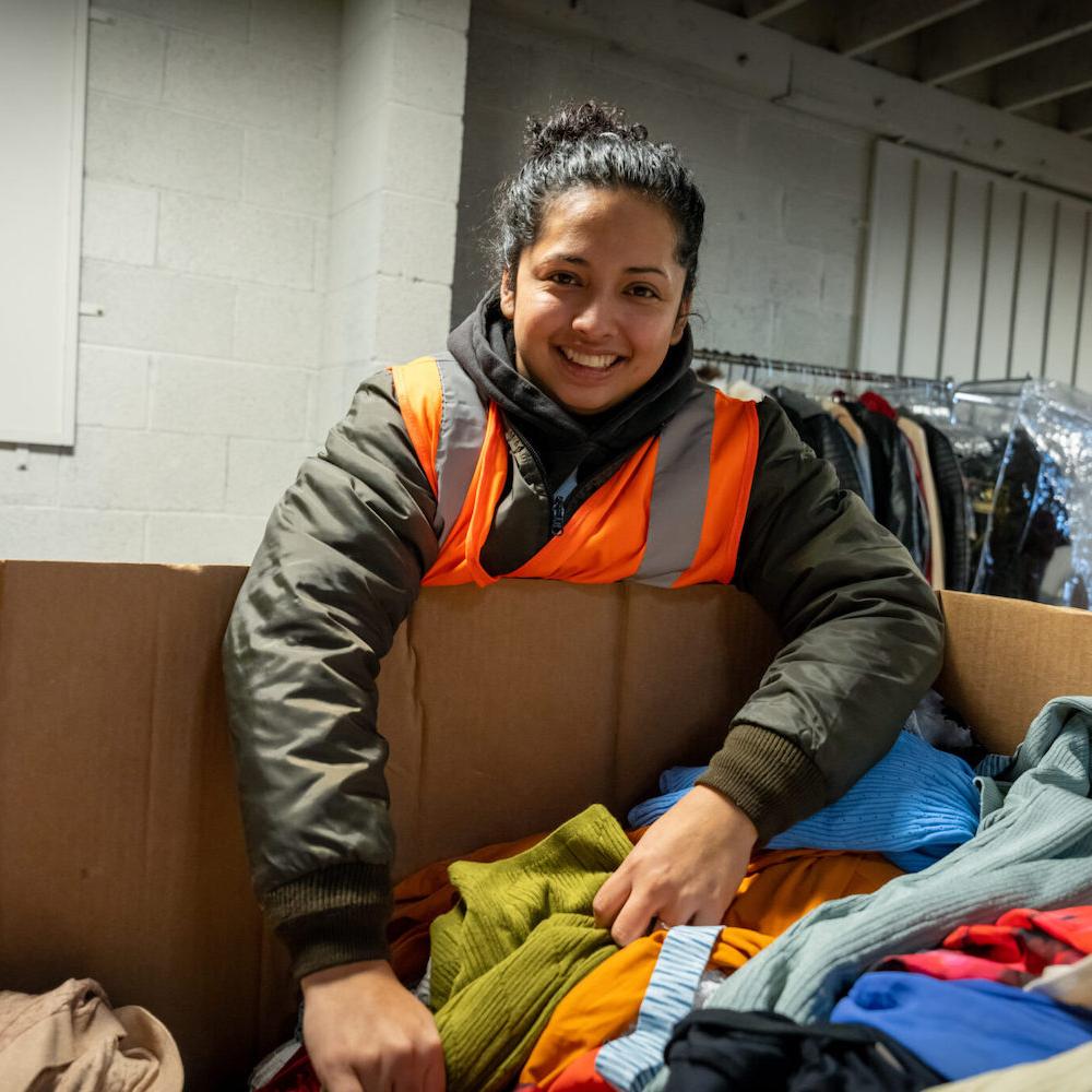 employee sorts clothes at Homeboy Threads - Homeboy Industries second chance hiring