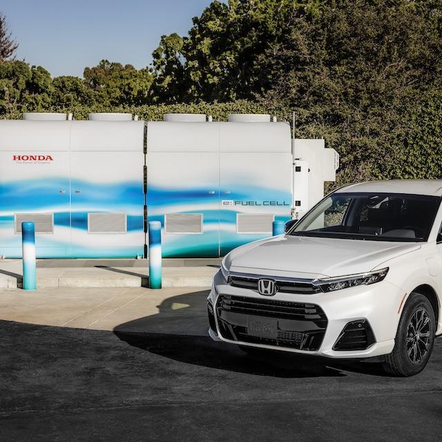 The new Honda CR-V e:FCEV next to the company's demonstration-scale fuel cell power station.