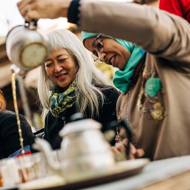 a local serves tea to travelers in Morocco - responsible travel