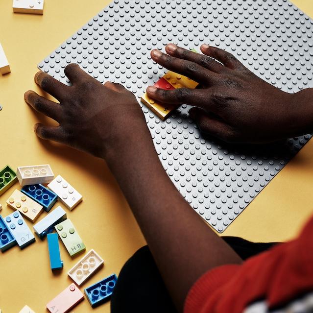 A child using Lego Braille Bricks. 