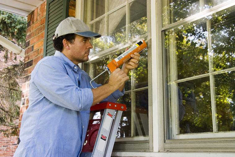 Mancaulkingwindowforenergyefficiency.jpeg