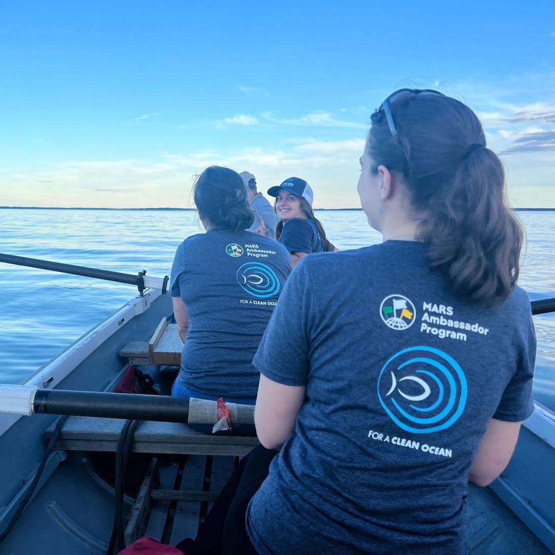 Mars employees on boat - volunteering to remove marine debris