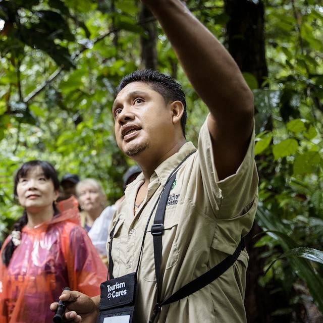 A local guide points out Panama’s biodiversity while walking through the rainforest with travelers — Meaningful Travel Map
