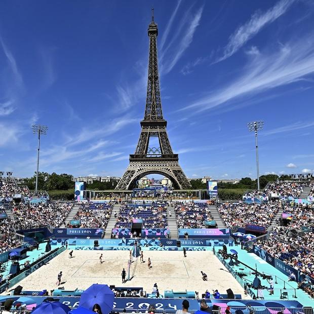 Paris Olympics 2024 — a crowd watches a womens volleyball match behind the eiffel tower