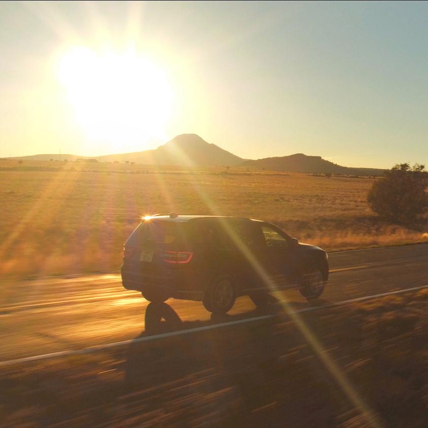 SUV driving down country road