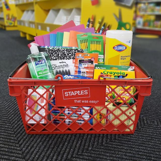 School supplies in a Staples shopping basket. 