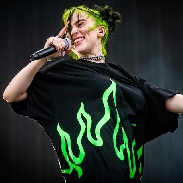 Billie Eilish singing into a mic. 