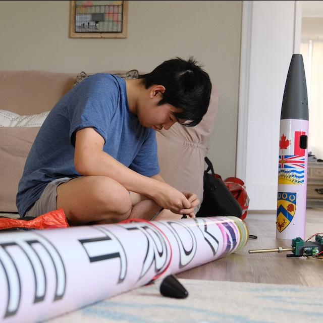 Jason Zhao working on the rocket he designed to detect and monitor a wildfire. 