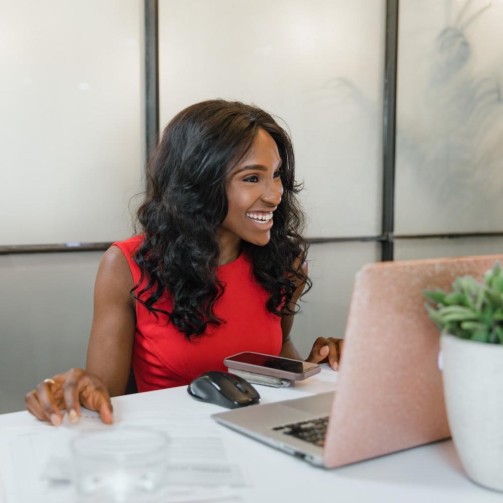 black woman entrepreneur takes meeting on laptop - minority-owned businesses